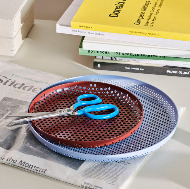 Lex Pott for HAY’s round Perforated Tray uses hundreds of tiny circular holes to create a structured effect. The round tray features curved, slightly raised sides for extra stability when carrying or displaying items. Made in aluminium in three sizes, and available in a variety of different colours.