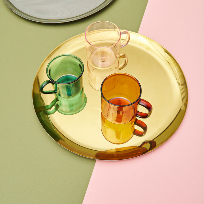 A simple, circular shape with a lustrous rainbow or gold finish results in this functional and decorative tray. HAY’s Serving Tray is made in stainless steel and can be used for desks and miscellaneous household objects.