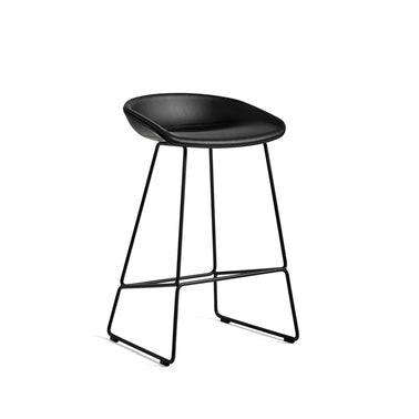 The bar stool About A Stool AAS39 has the same capacity for transformation as the other members in the series, ranging from a minimalistic plastic stool to a more full-bodied upholstered version. The curved backrest is balanced on an elegant rounded frame in metal, showcasing a more industrial design with a strong visual presence. Suitable for as using as a bar stool in bars and restaurants, as well as at home for informal meals.