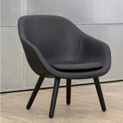 The About A Lounge Chair has a compact body with shaped armrests combined with round wooden legs. In line with the rest of the series, the sculpted design has been kept simple, with nothing left to chance. It is available in a low-backed version with a more intimate expression or a high-backed version with an open, spacious composition. 