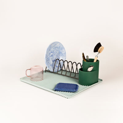 A trio of functional designs for draining the dishes, Shane Schneck’s Dish Drainer comprises a ridged melamine tray, steel plate rack and silicone cutlery holder. The contrasting shapes, materials and colours add visual interest to this everyday kitchen essential.