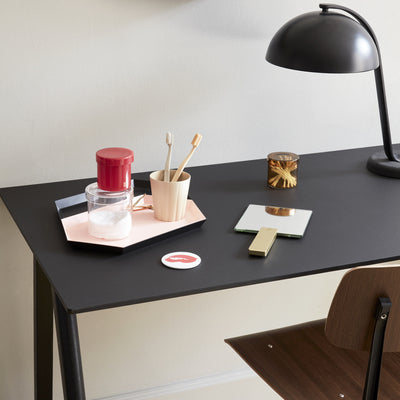 The double hand mirror is a functional cross between the wall-mounted mirror and the small portable make-up mirror. Mirror Mirror is made of aluminium and mirror glass and is available in a square version with a matt black handle and a round version with a brass handle.