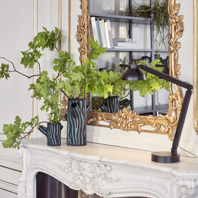 Tree Trunk is a collection of iconic decorative vases made in a stoneware ceramic. Glazed on the inside and hand-painted on the outside, the large three-armed or small two-armed versions feature the artist’s signature wood grain pattern on the tree trunk-shaped vase.