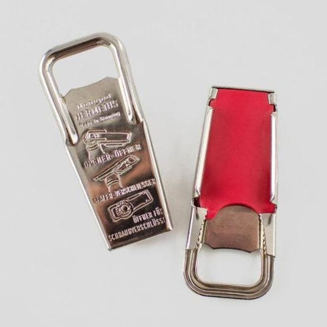 The Steel Bottle Opener and Resealer is made in polished steel with a rubber inlay to easily remove bottle tops or reseal them by sliding the rubber panel across. Made in Germany.