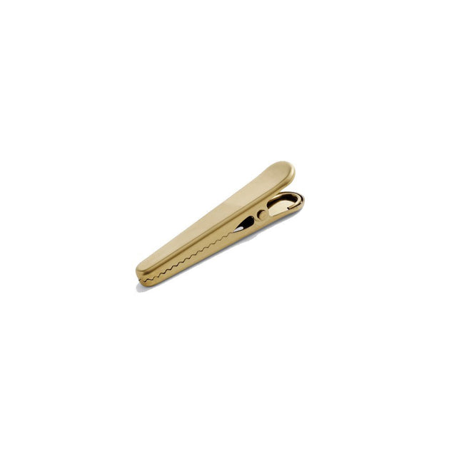Clip Clip is a series of practical golden devices for sealing bags in your kitchen or keeping track of papers on your desk.